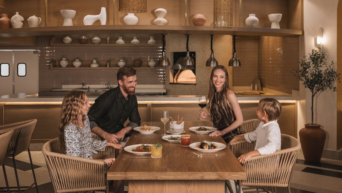 a family sitting at a table with food