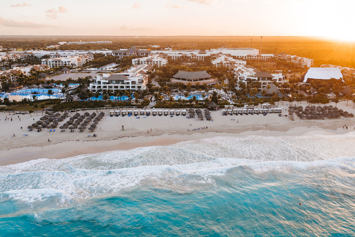a beach with many buildings and a body of water