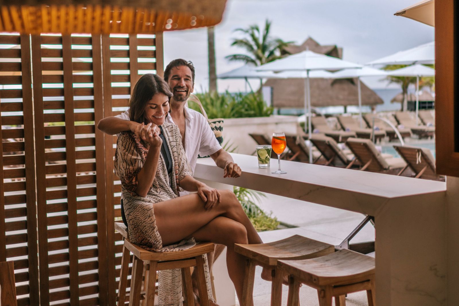 a man and woman sitting at a bar
