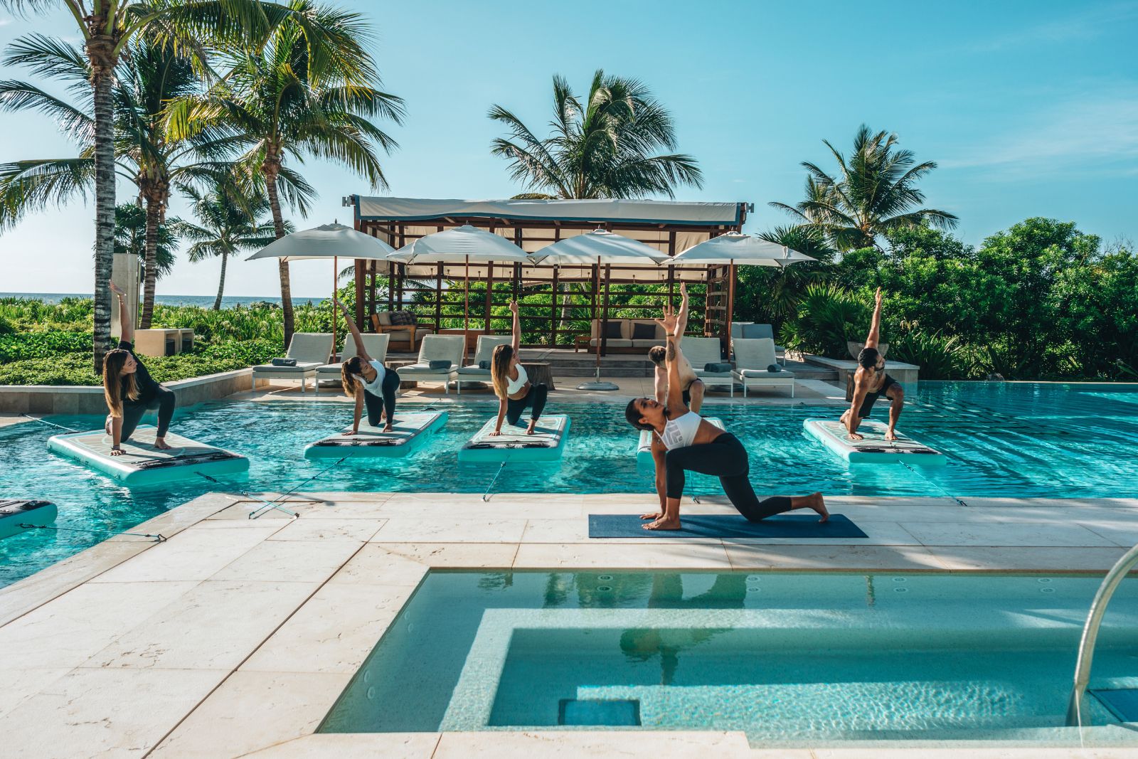 um grupo de pessoas fazendo yoga em uma piscina